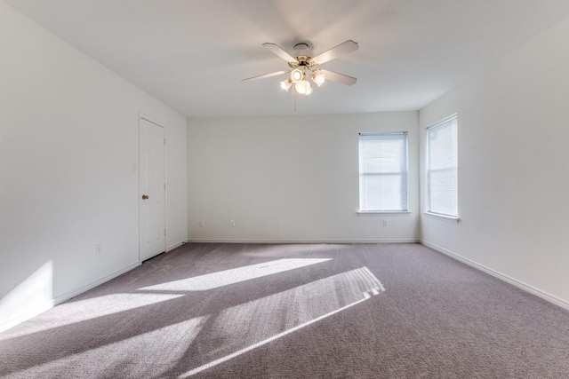 carpeted spare room with ceiling fan