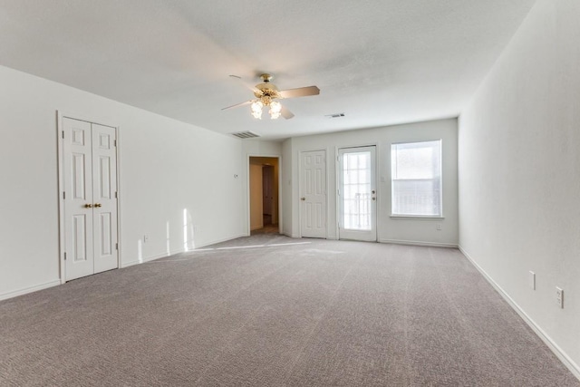 unfurnished room featuring ceiling fan and light colored carpet