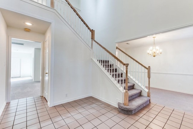 stairs featuring carpet, a high ceiling, and a notable chandelier