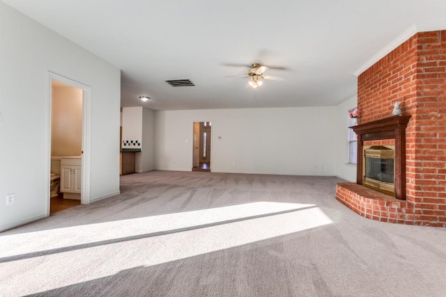 unfurnished living room with ceiling fan, light carpet, and a brick fireplace