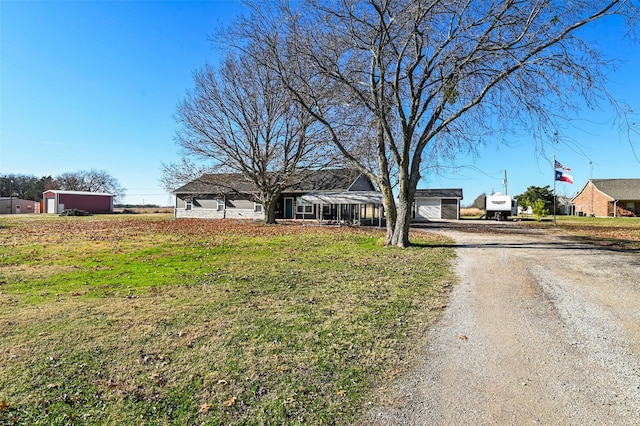 view of front of home featuring a front yard and a garage