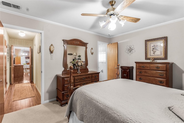 bedroom with ceiling fan, light hardwood / wood-style flooring, and ornamental molding