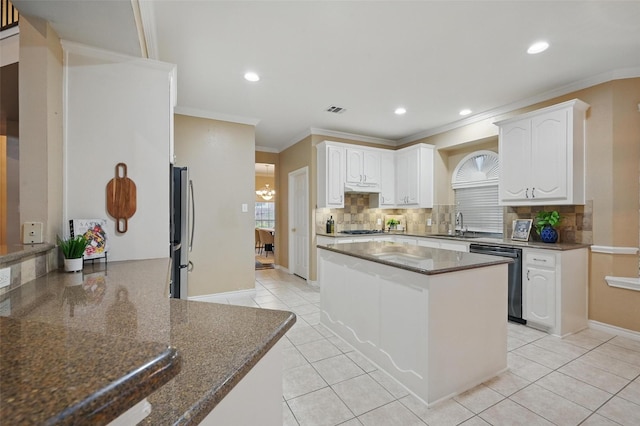 122 Wentwood Dr, Murphy, TX 75094 - kitchen featuring appliances with stainless steel finishes, backsplash, dark stone counters, light tile patterned flooring, and crown molding