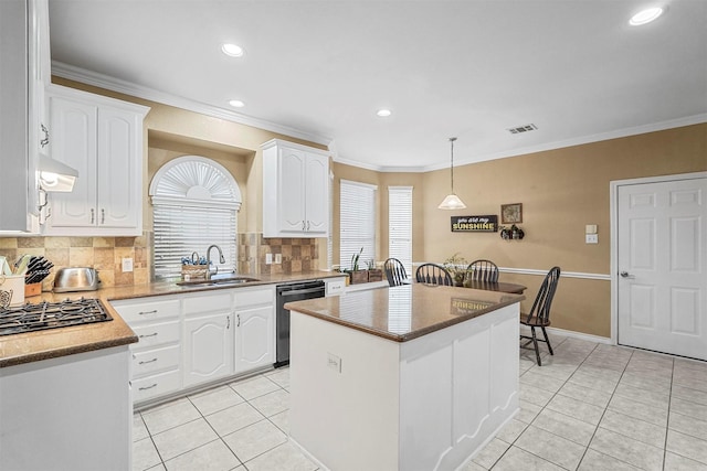 kitchen with sink, decorative backsplash, black dishwasher, a kitchen island, and white cabinetry