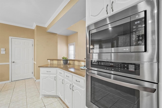 kitchen featuring white cabinets, double wall oven, light tile patterned floors, ornamental molding, and stone countertops