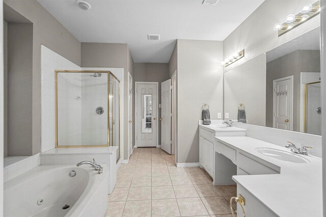 bathroom with tile patterned floors, vanity, and shower with separate bathtub