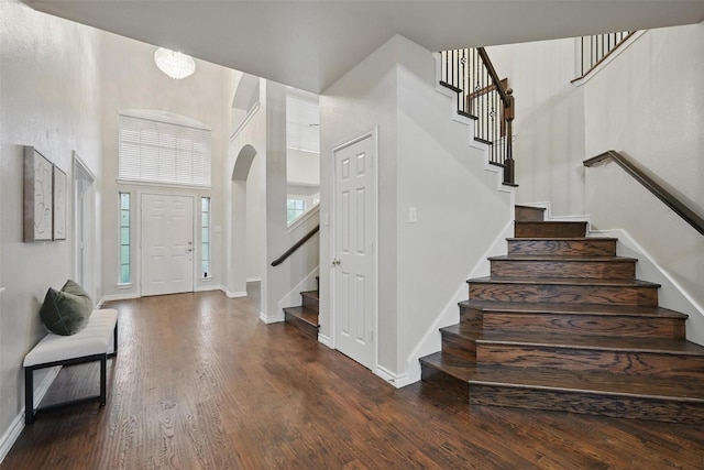 122 Wentwood Dr, Murphy, TX 75094 - entryway with stairs, arched walkways, wood finished floors, and a towering ceiling