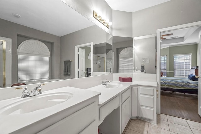 bathroom with tile patterned flooring, vanity, and walk in shower