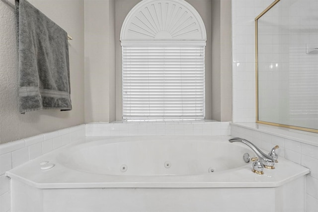 bathroom featuring a tub to relax in