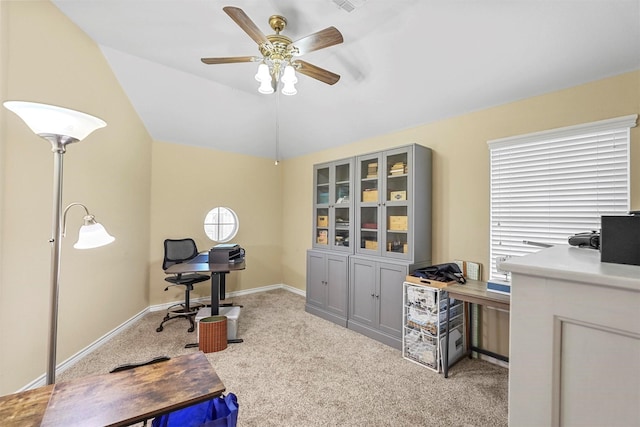 carpeted office space with ceiling fan and vaulted ceiling