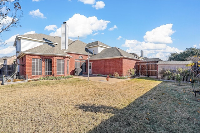122 Wentwood Dr, Murphy, TX 75094 - rear view of property featuring brick siding, a patio, a fenced backyard, and a shingled roof