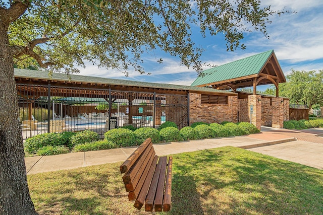 view of community with a lawn and a swimming pool