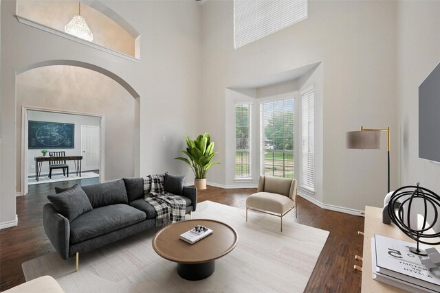 122 Wentwood Dr, Murphy, TX 75094 - living area with arched walkways, a high ceiling, and wood finished floors