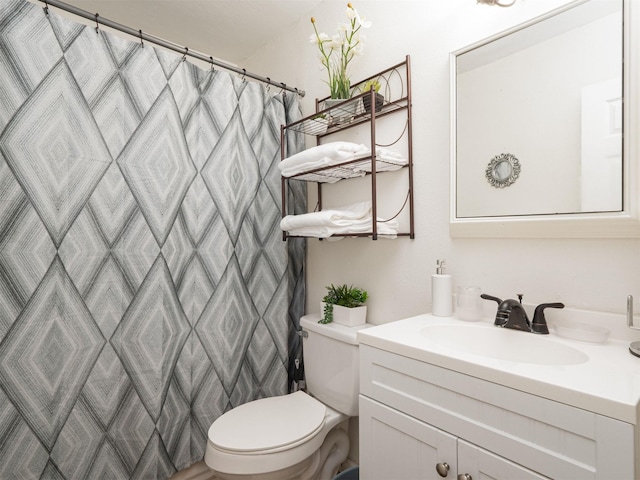 bathroom featuring vanity, toilet, and walk in shower