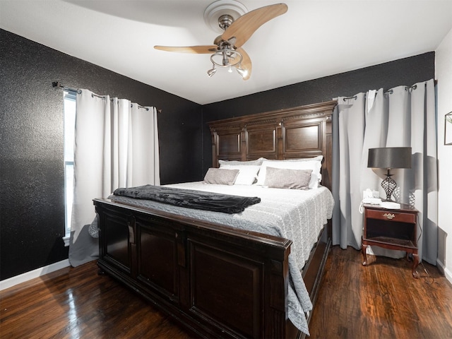 bedroom featuring ceiling fan and dark hardwood / wood-style flooring