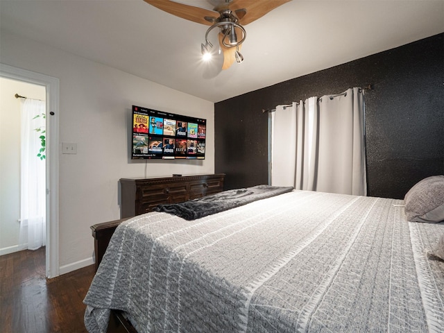 bedroom featuring dark hardwood / wood-style flooring and ceiling fan