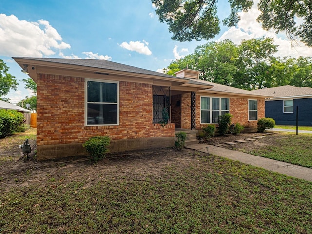 ranch-style home with a front lawn