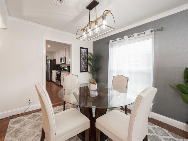 dining space featuring crown molding and dark wood-type flooring