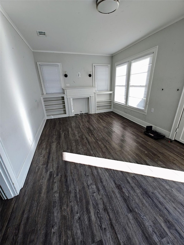 unfurnished living room featuring dark wood-type flooring and ornamental molding