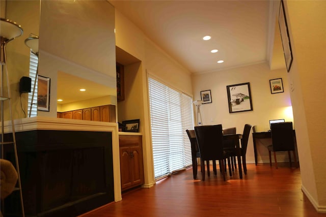 dining area featuring dark hardwood / wood-style flooring and ornamental molding