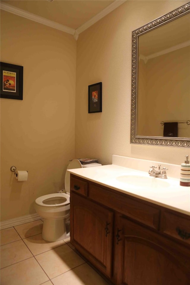 bathroom featuring toilet, vanity, tile patterned floors, and ornamental molding