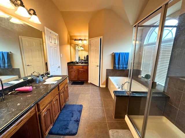 bathroom featuring tile patterned flooring, vanity, lofted ceiling, and plus walk in shower