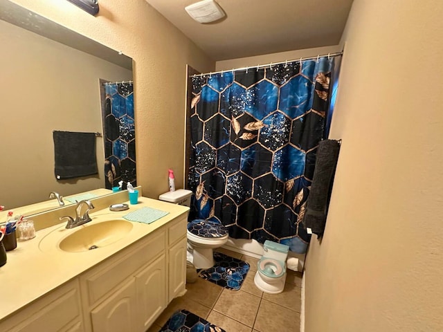 bathroom with toilet, vanity, tile patterned floors, and walk in shower