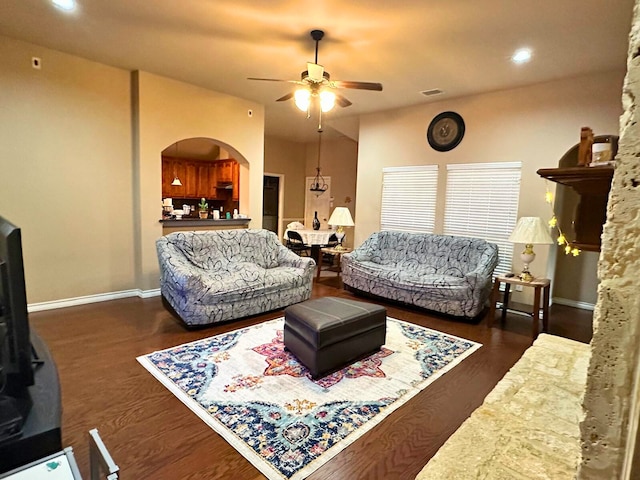 living room with ceiling fan and dark hardwood / wood-style floors