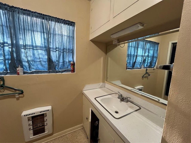 clothes washing area featuring sink and heating unit