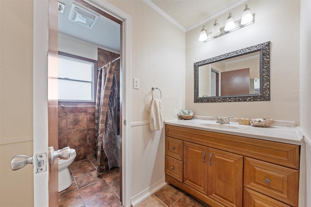 bathroom featuring tile patterned flooring, vanity, a textured ceiling, and ornamental molding