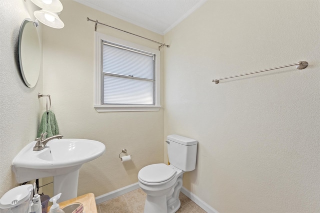 bathroom with tile patterned floors, toilet, and ornamental molding