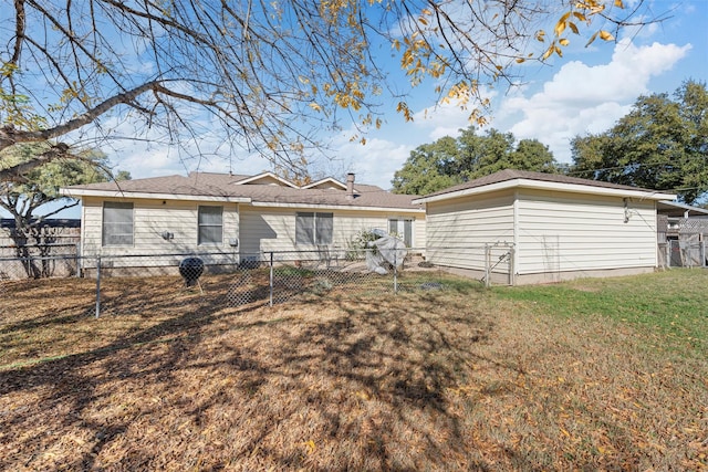 rear view of house with a yard