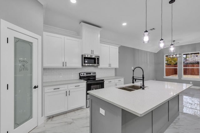 kitchen with a center island with sink, white cabinetry, sink, and appliances with stainless steel finishes