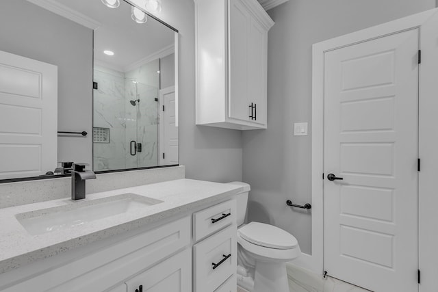 bathroom with crown molding, vanity, an enclosed shower, and toilet