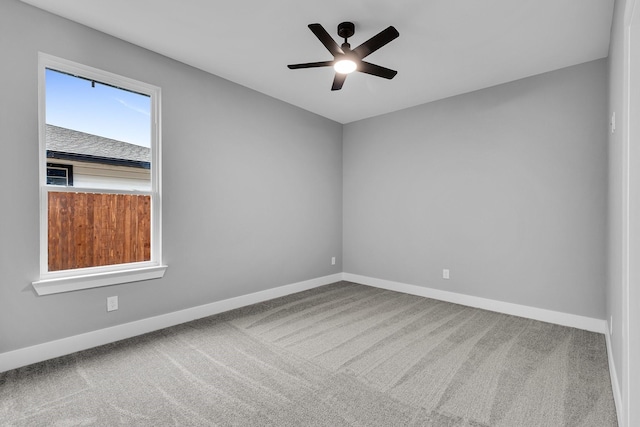 empty room with ceiling fan and carpet floors