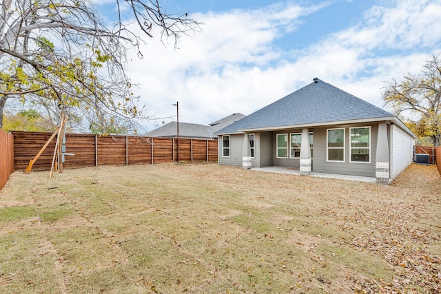 rear view of property with central AC unit