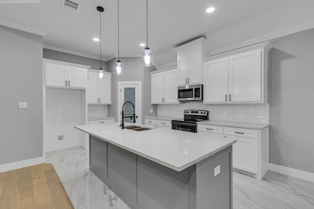 kitchen featuring sink, white cabinets, decorative light fixtures, and appliances with stainless steel finishes