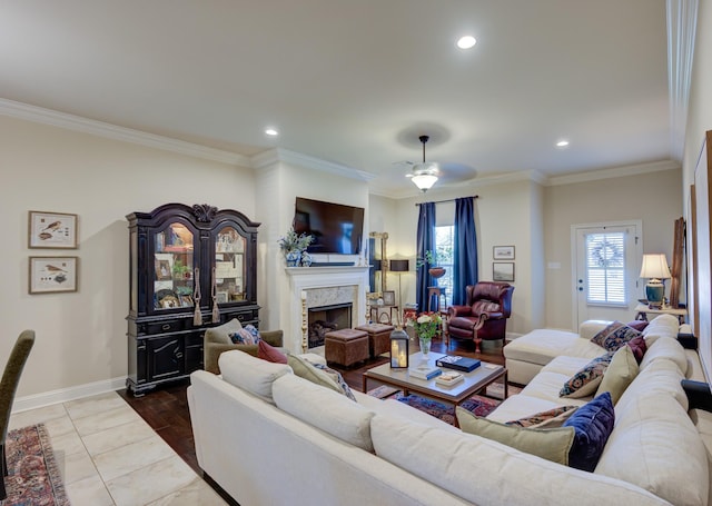 living room with a fireplace, ceiling fan, and ornamental molding