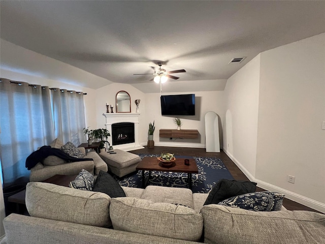 living room with hardwood / wood-style flooring, vaulted ceiling, and ceiling fan