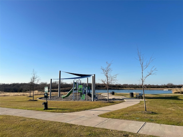 view of jungle gym with a yard and a water view