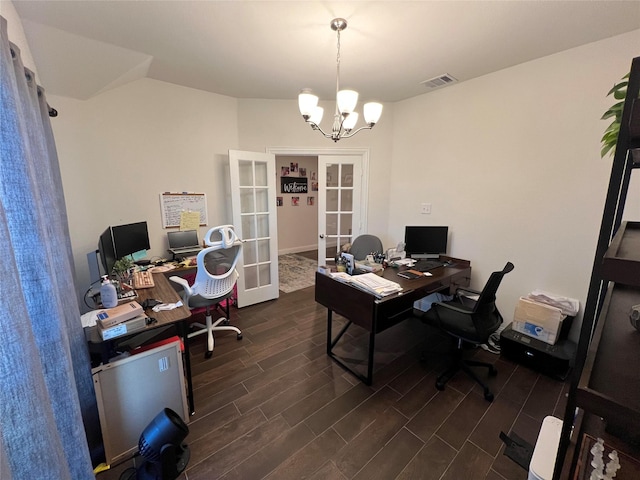 office featuring dark hardwood / wood-style flooring, french doors, and an inviting chandelier