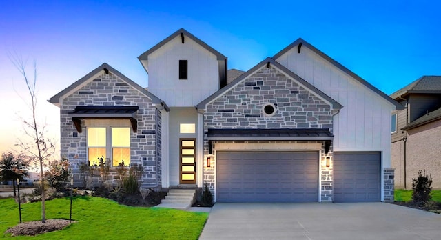 view of front of home featuring concrete driveway, stone siding, an attached garage, board and batten siding, and a front yard