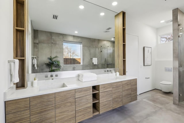 bathroom featuring toilet, concrete floors, an enclosed shower, and vanity