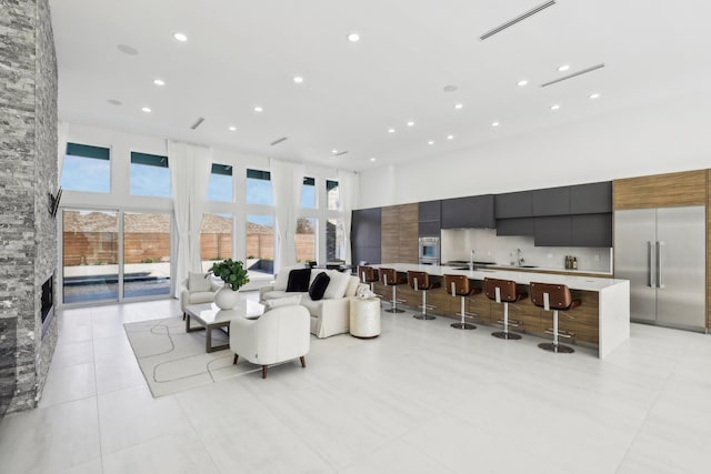 dining area featuring a healthy amount of sunlight, light tile patterned flooring, and a high ceiling