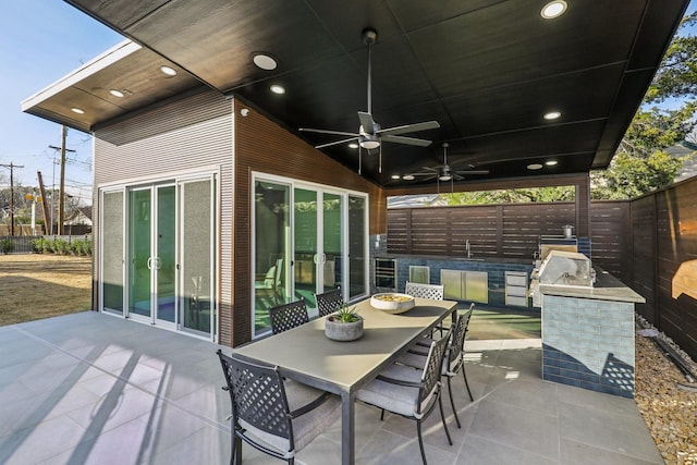 view of patio with exterior kitchen, sink, and ceiling fan