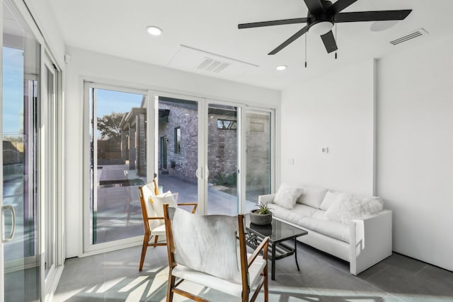 sunroom featuring ceiling fan