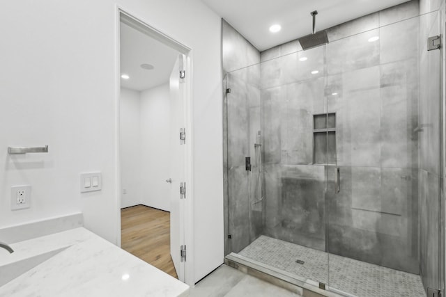 bathroom with vanity and a shower with door