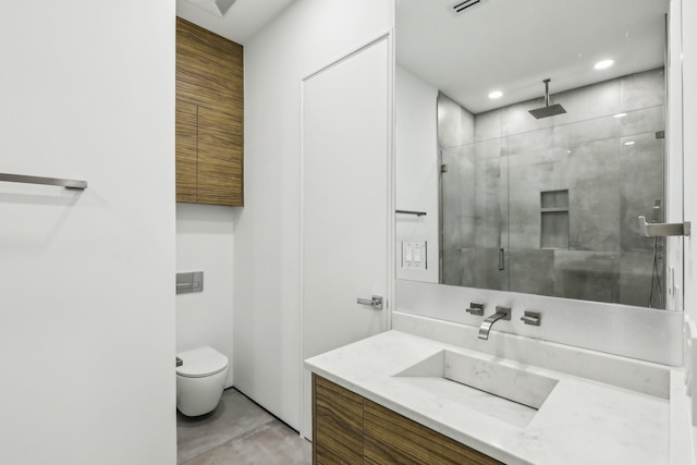 bathroom featuring an enclosed shower, vanity, and toilet