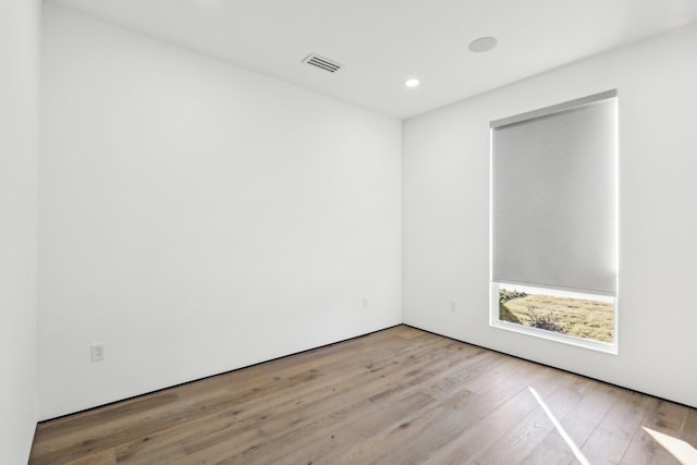 empty room with light hardwood / wood-style flooring