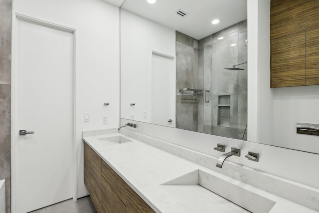 bathroom featuring an enclosed shower and vanity